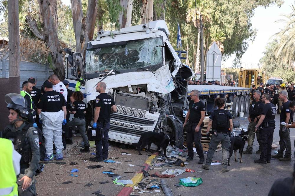 Israeli police and emergency responders secure the truck after a driver rammed his vehicle into a crowd of people at a bus stop in Ramat Hasharon, north of Tel Aviv on Sunday. AFP