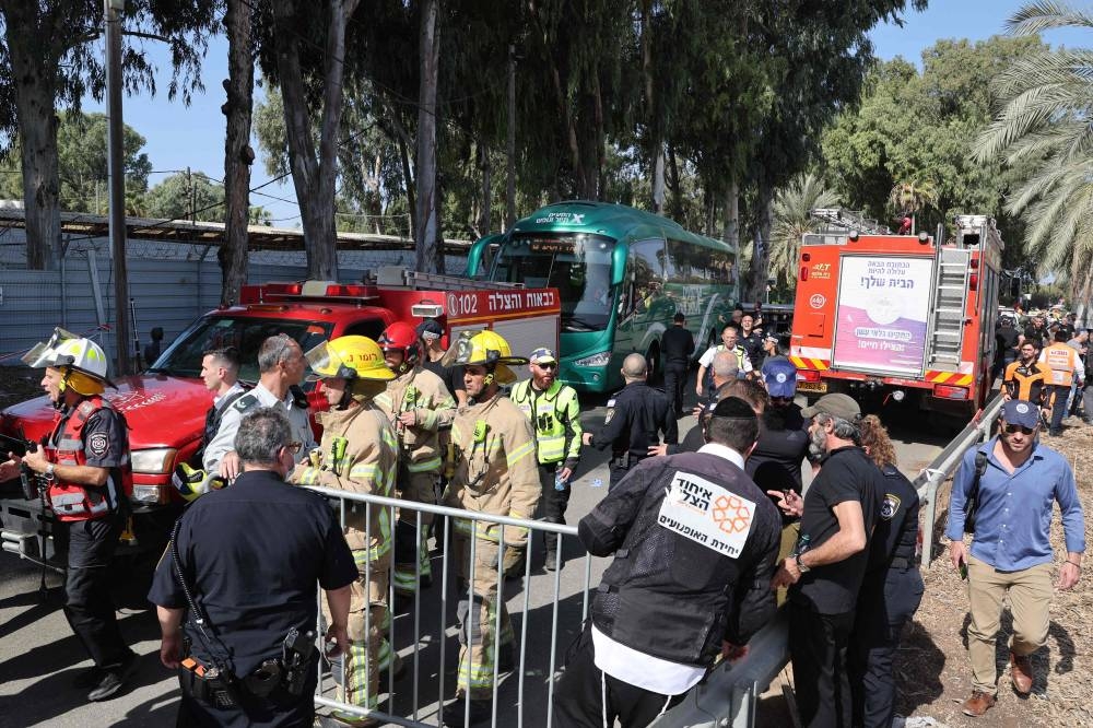 Israeli police and firefighters secure the site of a ramming attack in Ramat Hasharon, north of Tel Aviv on Sunday. AFP