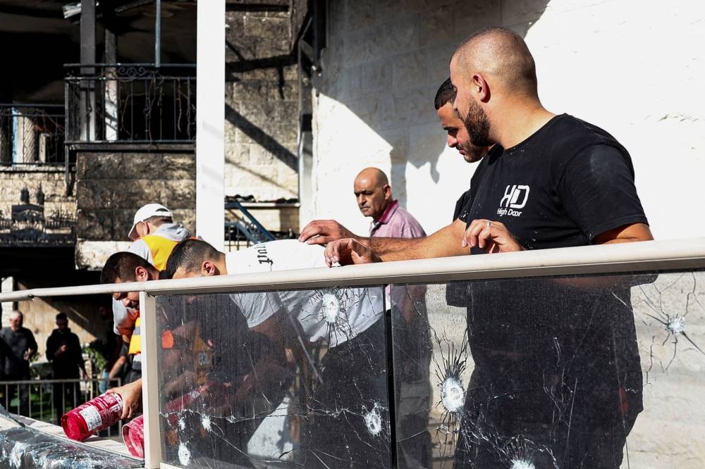 People inspect damages at a site of a house damaged after a barrage of rockets was fired from Lebanon into Israel, in Tamra, northern Israel on Sunday. REUTERS