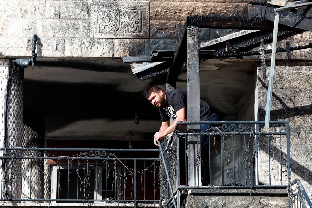 A man looks on at a site of a house damaged after a barrage of rockets was fired from Lebanon into Israel, in Tamra, northern Israel on Sunday. REUTERS