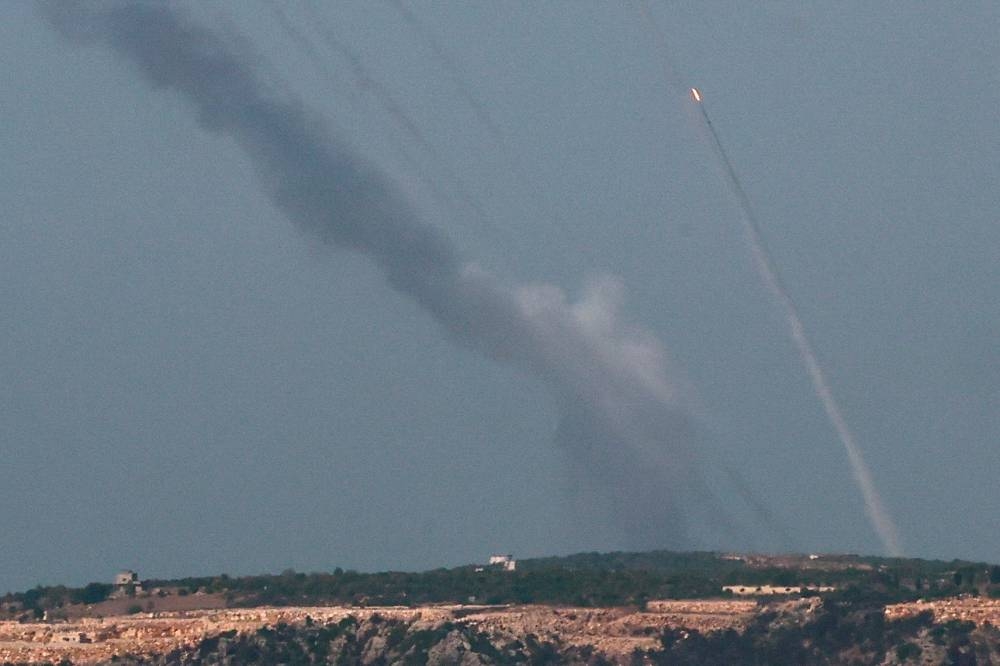 A barrage of rockets, fired from south of Lebanon to Israel flies, as seen from northern Israel on Sunday. REUTERS