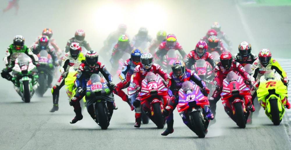 
Prima Pramac Racing’s Jorge Martin, Ducati Lenovo Team’s Francesco Bagnaia, Pertamina Enduro VR46 Racing Team’s Marco Bezzecchi and riders in action during the Thailand Grand Prix at Chang International Circuit, Buriram, Thailand, yesterday. Right: Francesco Bagnaia celebrates on the podium after winning the race. (Reuters/AFP) 