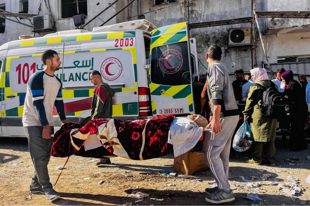 Medics evacuate injured people and cancer patients from the Kamal Adwan Hospital in Beit Lahia in the northern Gaza Strip on Monday, to al-Shifa hospital in Gaza City in a joint World Health Organisation and Palestinian Red Crescent initiative. AFP