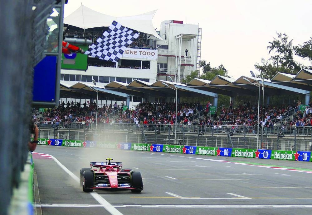 
Ferrari’s Spanish driver Carlos Sainz gets the chequered flag to clinch the Mexico City Grand Prix at the Hermanos Rodriguez racetrack, in Mexico City. (AFP) 