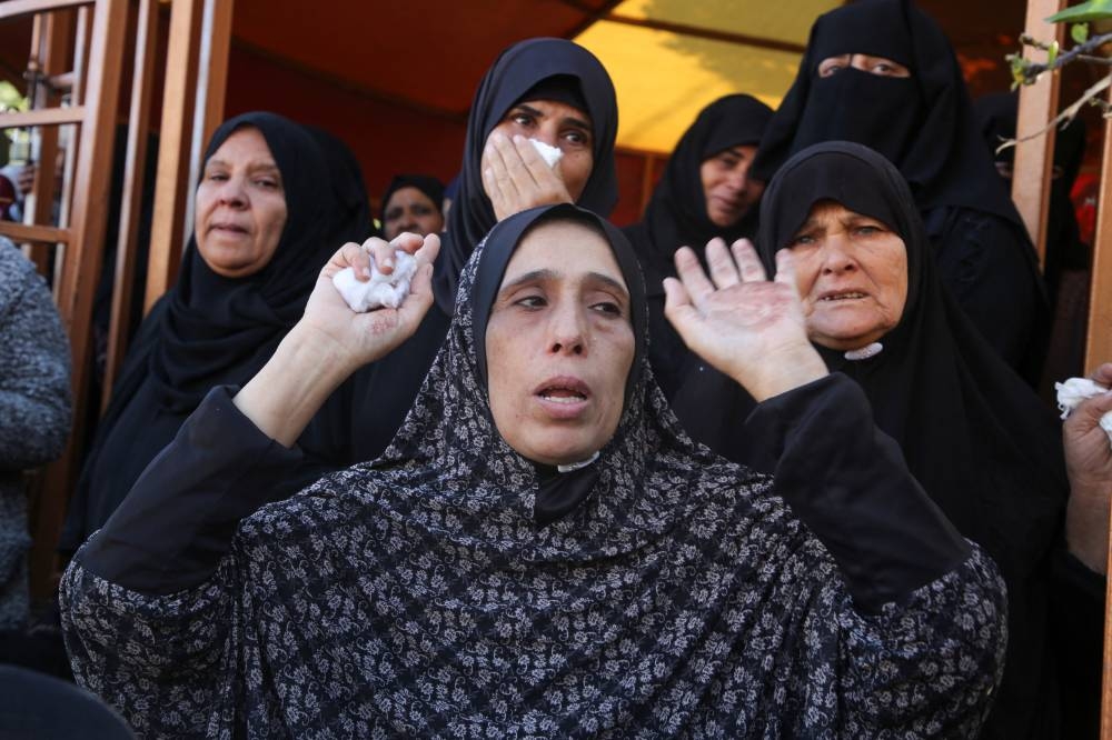 Mourners react near the bodies of Palestinians killed in an Israeli strike, in Khan Younis, in the southern Gaza Strip, on Wednesday. REUTERS