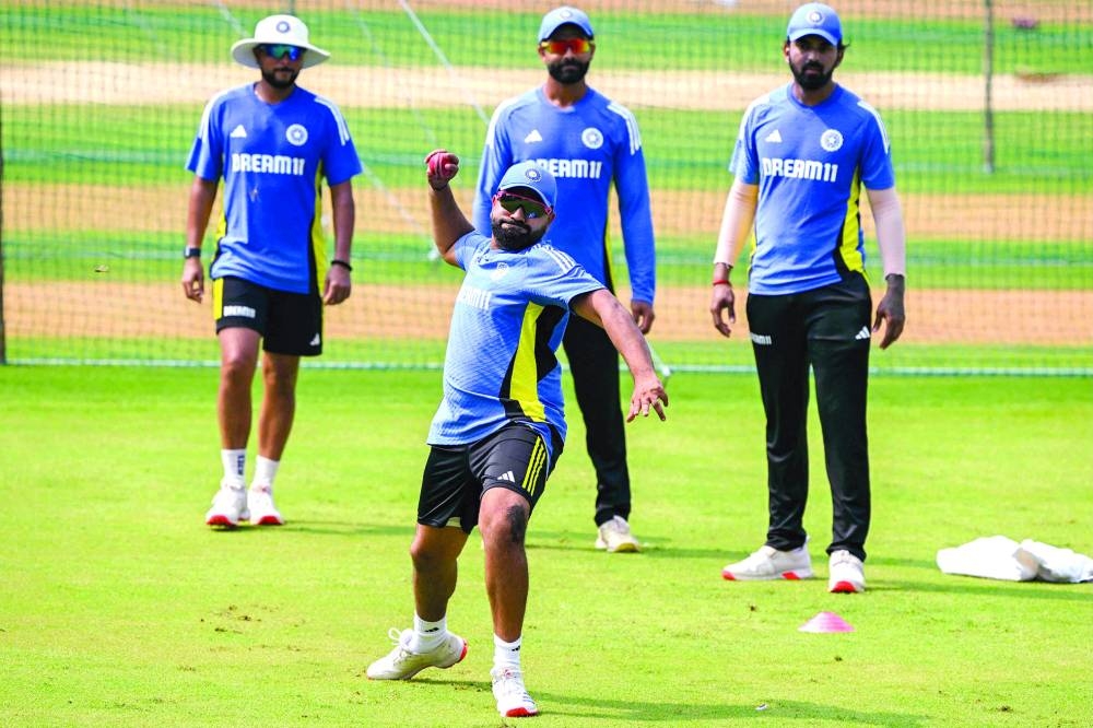 India’s captain Rohit Sharma throws a ball as Kuldeep Yadav (left), Ravindra Jadeja (second right) and 
KL Rahul watch during a practice session ahead of their third Test against New Zealand at the Wankhede Stadium in Mumbai yesterday. (AFP)