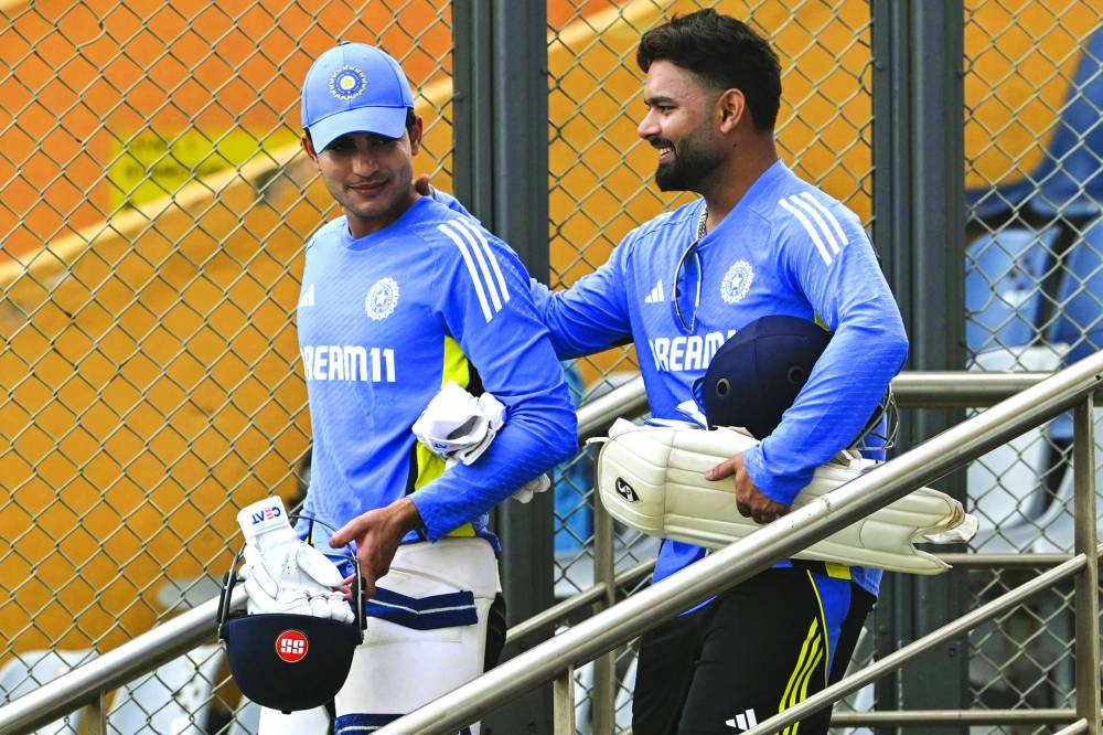 India’s Shubman Gill (left) and Rishabh Pant arrive for a practice session on the eve of their third Test against New Zealand at the Wankhede Stadium in Mumbai yesterday. Right: New Zealand’s Mitchell Santner (left) and Ish Sodhi attend a practice session. (AFP)