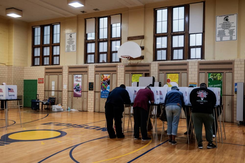 People vote in the 2024 US presidential election on Election Day in Detroit, Michigan, on Tuesday. REUTERS