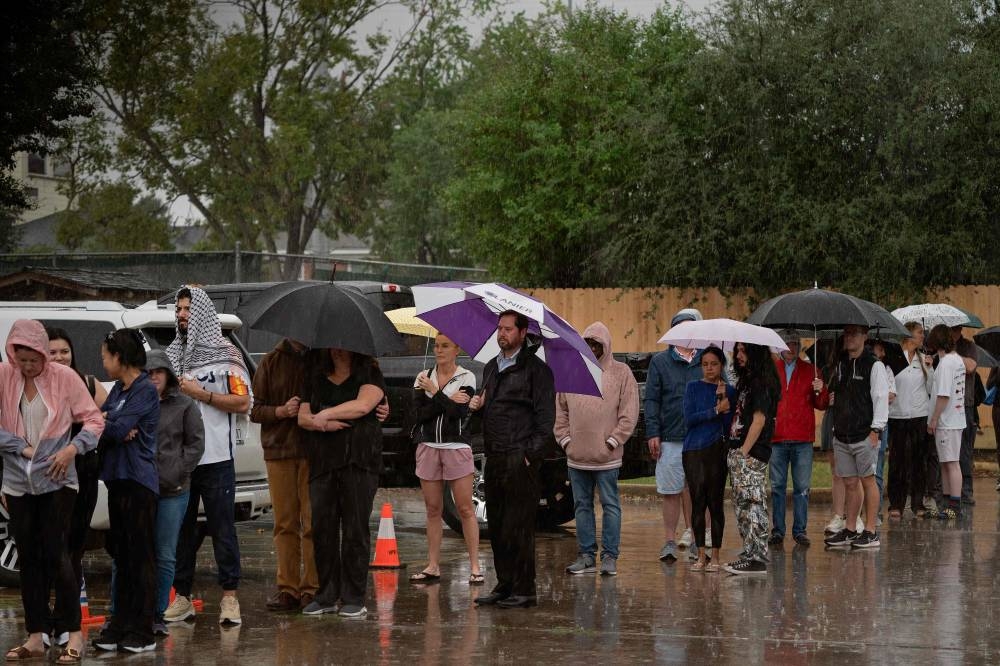 Despite heavy rain, people wait in line to vote in the US presidential election at the Metropolitan Multi-Service Center on Tuesday in Houston, Texas. AFP