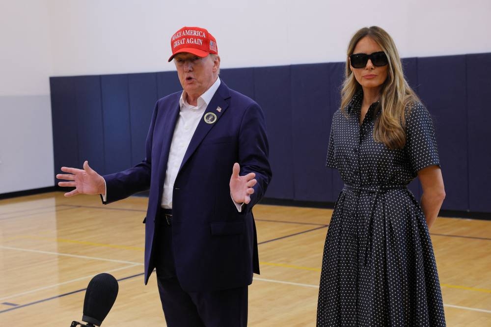 Republican presidential nominee and former US President Donald Trump, accompanied by former US first lady Melania Trump, speaks to reporters after voting at Mandel Recreation Center on Election Day in Palm Beach, Florida, on Tuesday. REUTERS
