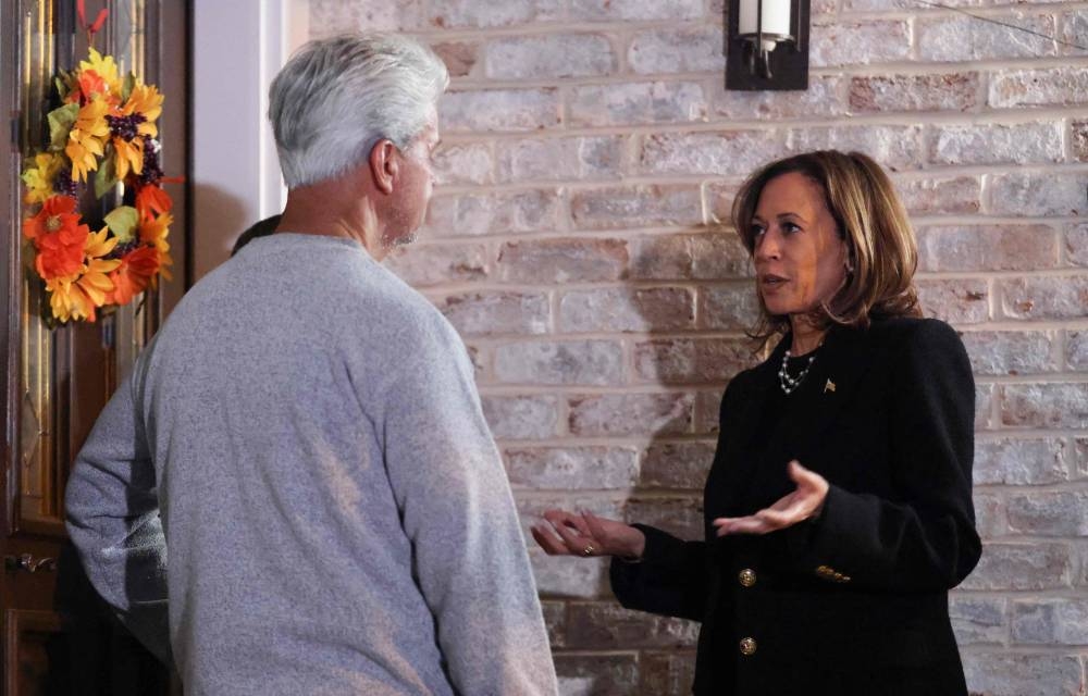 US Vice President and Democratic presidential candidate Kamala Harris speaks with a homeowner as she cavansses for votes in Muhlenberg, Pennsylvania, on Monday. AFP
