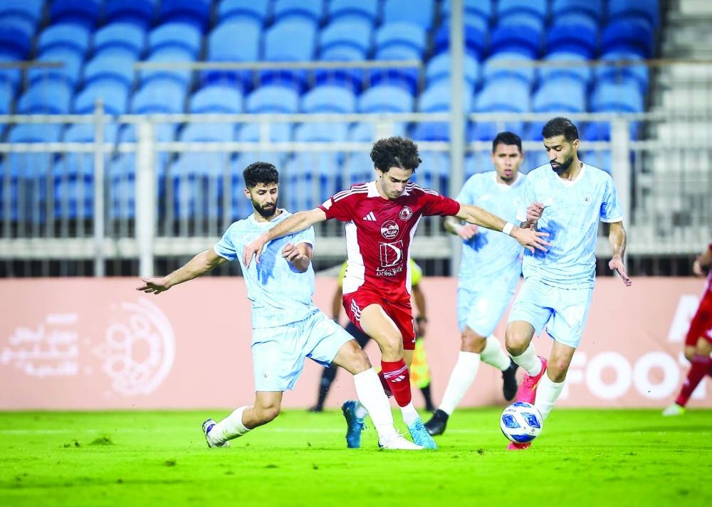 Al Arabi’s Ahmed Alaaeldin attempts to get past Al Riffa players during the Gulf Club Champions League match at the Khalifa Sports City Stadium in Manama yesterday.