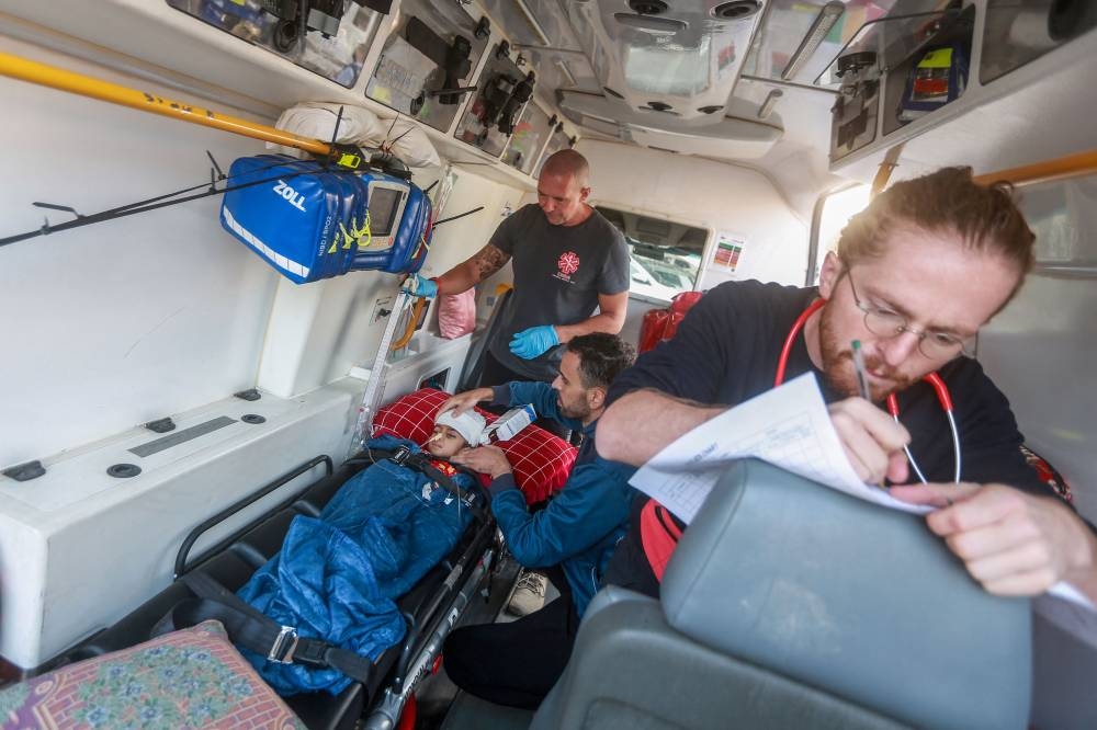 Medics set up a young patient in an ambulance as a convoy of the World Health Organization and the Palestinian Red Crescent prepares to take off from the European Hospital in Khan Yunis south of Gaza, evacuating patients and war-wounded from the besieged Palestinian territory to several Arab and other countries on Wednesday. AFP