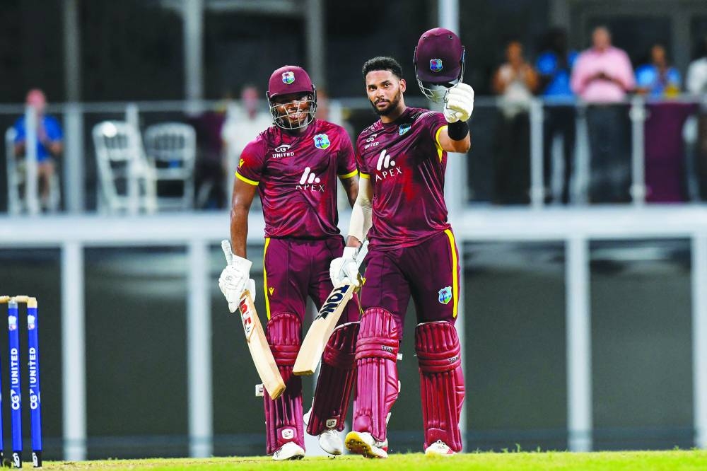
Keacy Carty (left) smiles as Brandon King of West Indies celebrates his century during the 3rd and final ODI against England at Kensington Oval, Bridgetown, Barbados. (AFP) 