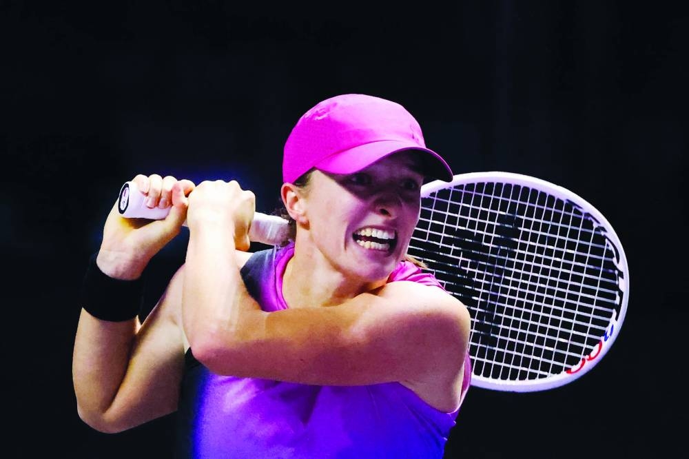 
Poland’s Iga Swiatek hits a return against Russia’s Daria Kasatkina during their match at the WTA Finals Championship in Riyadh yesterday. (AFP) 