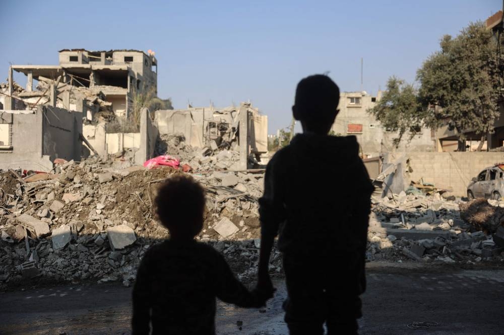 Children stare at the destruction following an Israeli strike in the Nuseirat refugee camp in the central Gaza Strip on Thursday. AFP