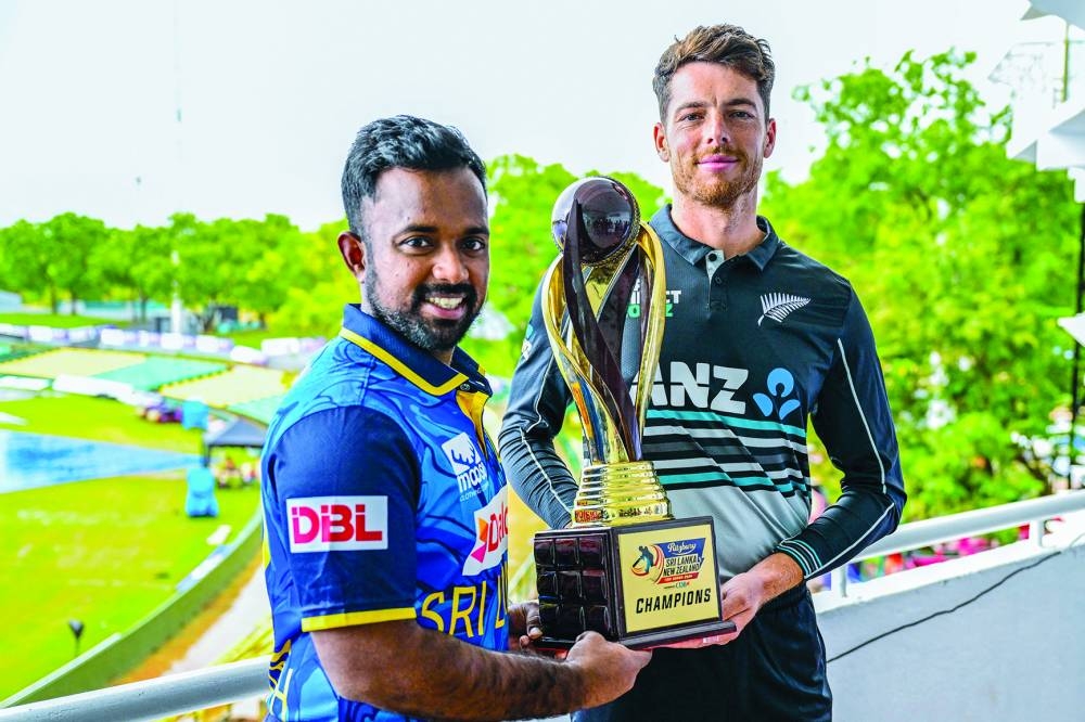 Sri Lanka’s captain Charith Asalanka (left) and his New Zealand’s counterpart Mitchell Santner pose with the Twenty20 series trophy in Dambulla yesterday. (AFP) 