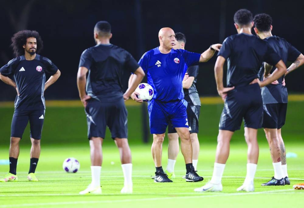 Qatar coach Marquez Lopez talks to his players during a training session at the Aspire Academy yesterday.