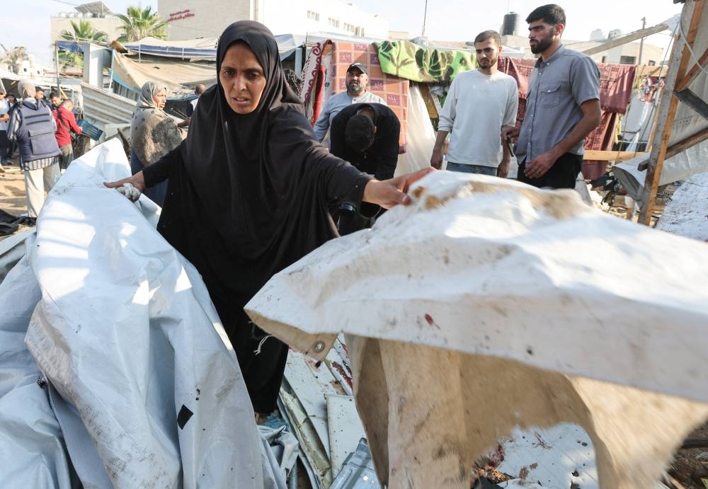 Palestinians inspect the site of an Israeli strike on a tent housing displaced people, at Al-Aqsa Martyrs Hospital in Deir Al-Balah, in the central Gaza Strip, on Saturday. REUTERS