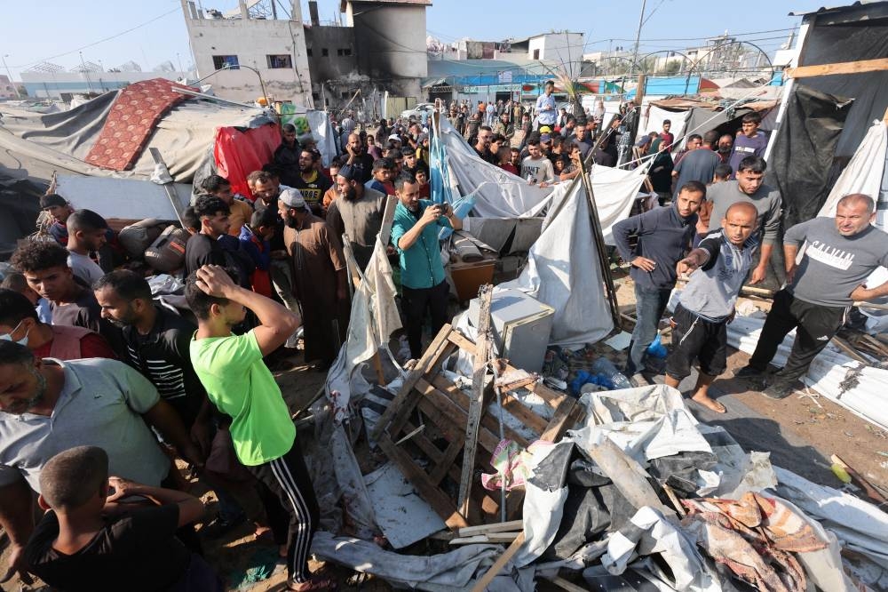 Palestinians inspect the site of an Israeli strike on a tent housing displaced people, at Al-Aqsa Martyrs Hospital in Deir Al-Balah, in the central Gaza Strip, on Saturday. REUTERS