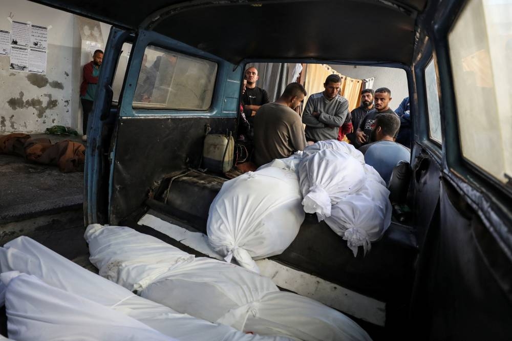 The bodies of Palestinians, killed in an Israeli strike on a house in Jabalia, are placed in a vehicle, at Al-Ahli hopsital in Gaza City, on Sunday. REUTERS
