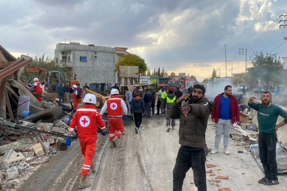 Rescuers from the Lebanese Red Cross search for victims and survivors at the site of an Israeli airstrike that targeted the village of Rasm El-Hadath in the eastern Lebanese Bekaa valley, on Sunday. AFP