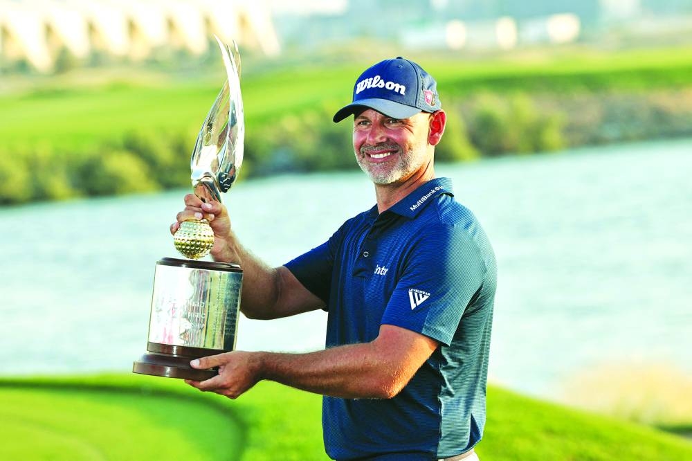 
England’s Paul Waring holds the winner’s trophy after winning the Abu Dhabi Championship yesterday. (AFP) 