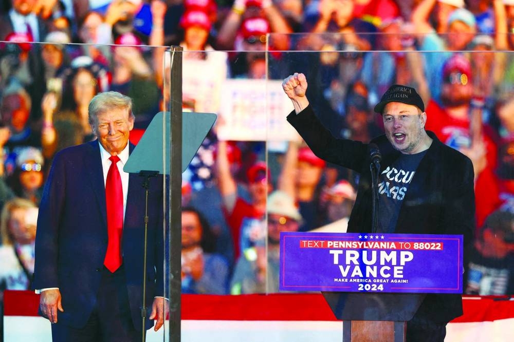 Tesla CEO and X owner Elon Musk speaks as Republican presidential nominee and former US president Donald Trump looks on during a rally at the site of the July assassination attempt against Trump, in Butler, Pennsylvania, last month. (Reuters)