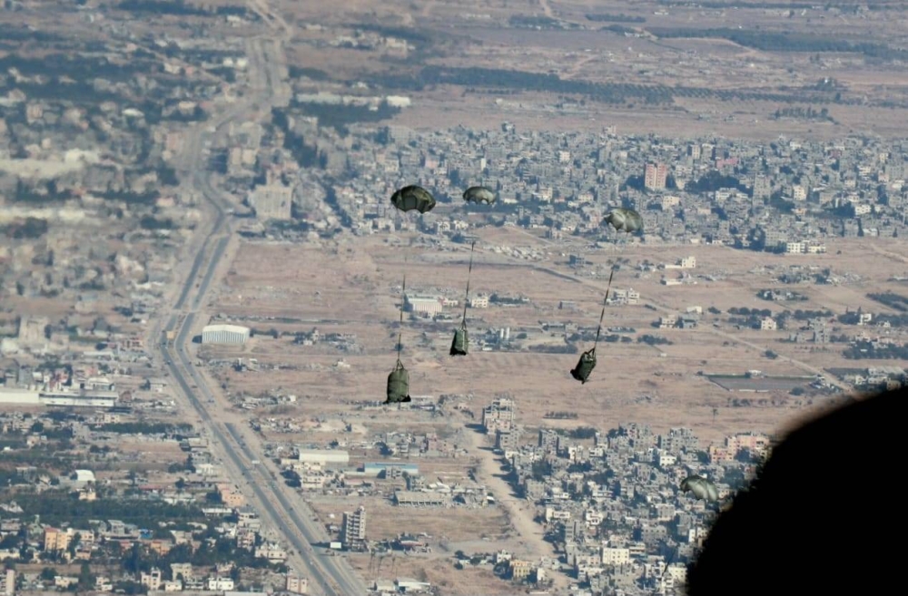 A handout picture released by the official Jordanian news agency Petra shows an airdrop of humanitarian and relief aid to the southern Gaza Strip carried out by members of the Jordanian army, on Tuesday. AFP