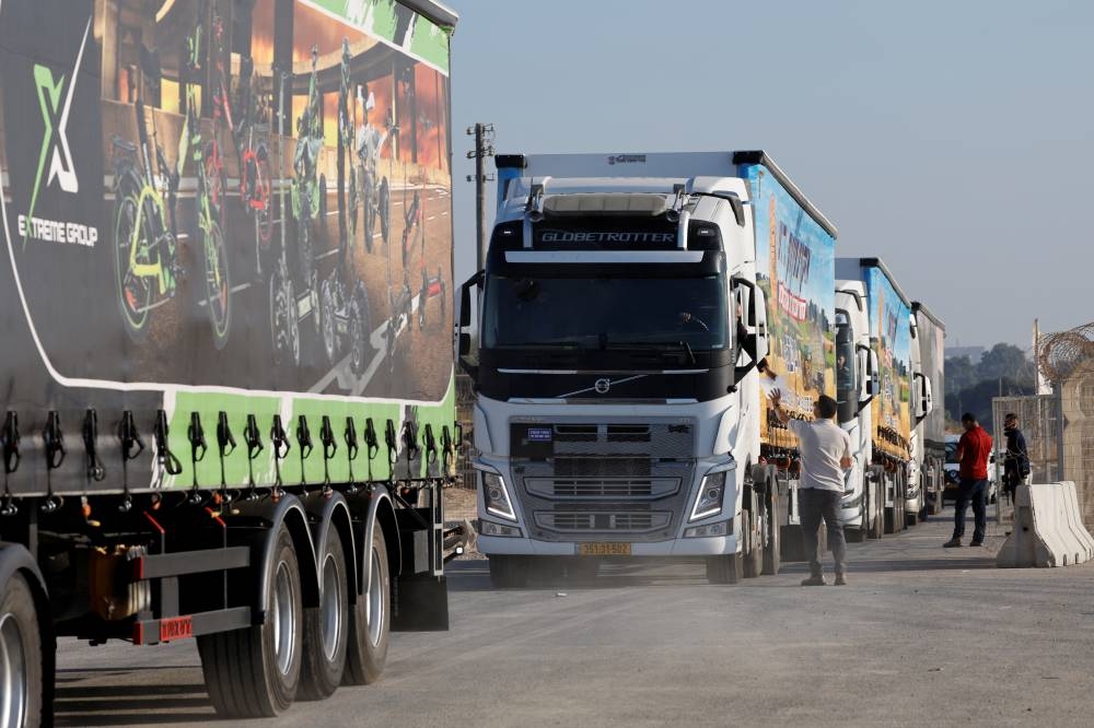 Trucks carrying humanitarian aid destined for the Gaza Strip queue at the Kerem Shalom crossing in southern Israel, on Monday. REUTERS