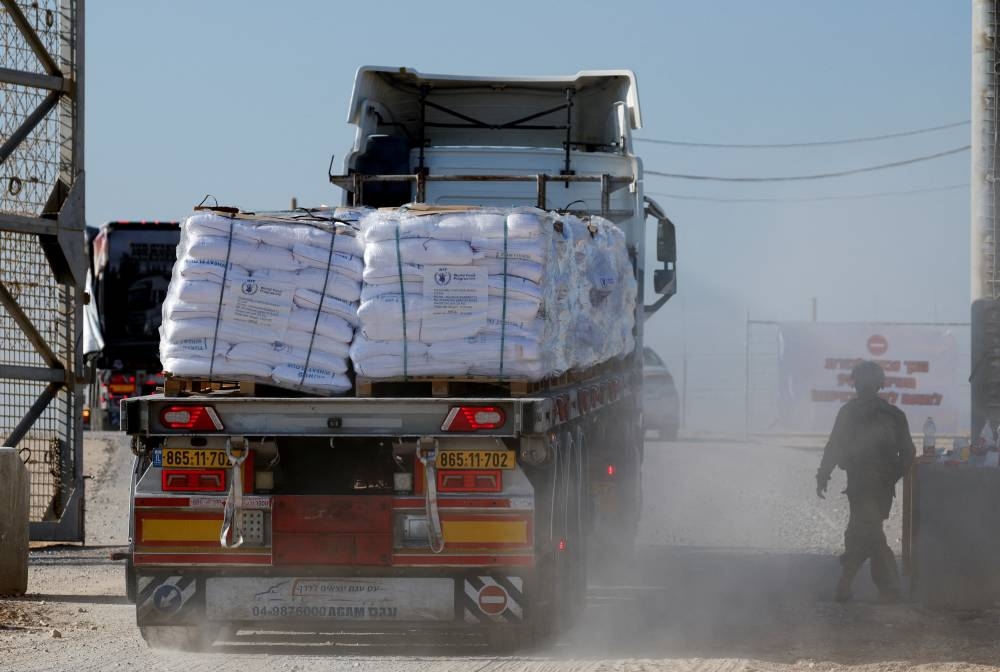 A truck carries humanitarian aid destined for the Gaza Strip at the Kerem Shalom crossing in southern Israel, on Monday. REUTERS