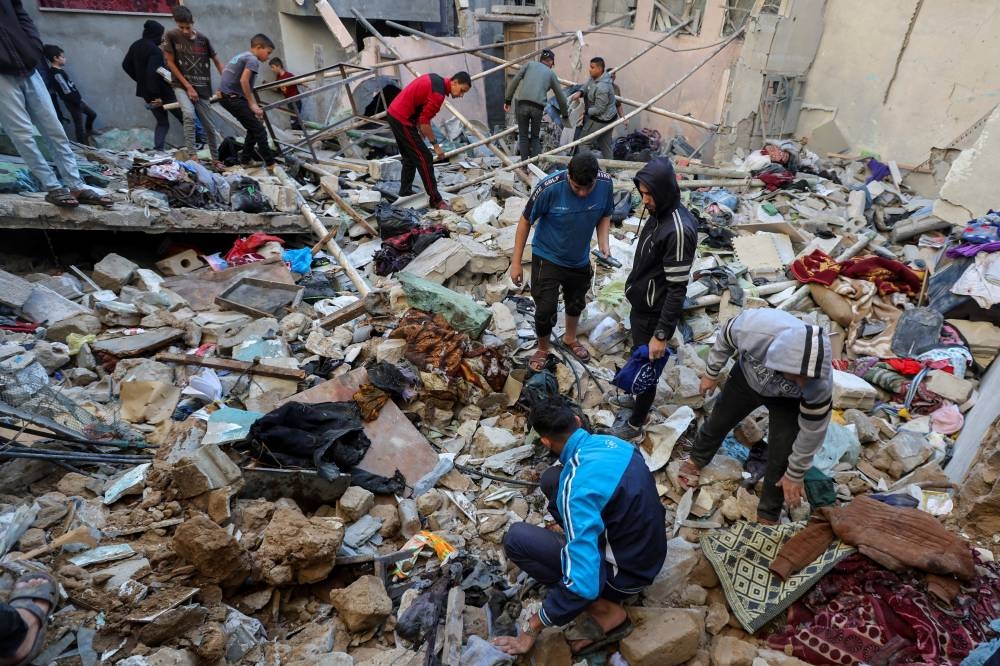 Palestinians inspect the site of an Israeli strike on a house in Nuseirat in the central Gaza Strip, on Wednesday. REUTERS