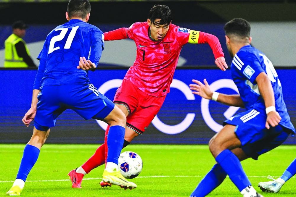 Kuwait’s defender Hassan Hamdan al-Enezi attempts to cut off South Korea’s forward Son Heung-min during the 2026 FIFA World Cup Asian qualification match at Jaber Al-Ahmad International Stadium in Kuwait City yesterday. (AFP)