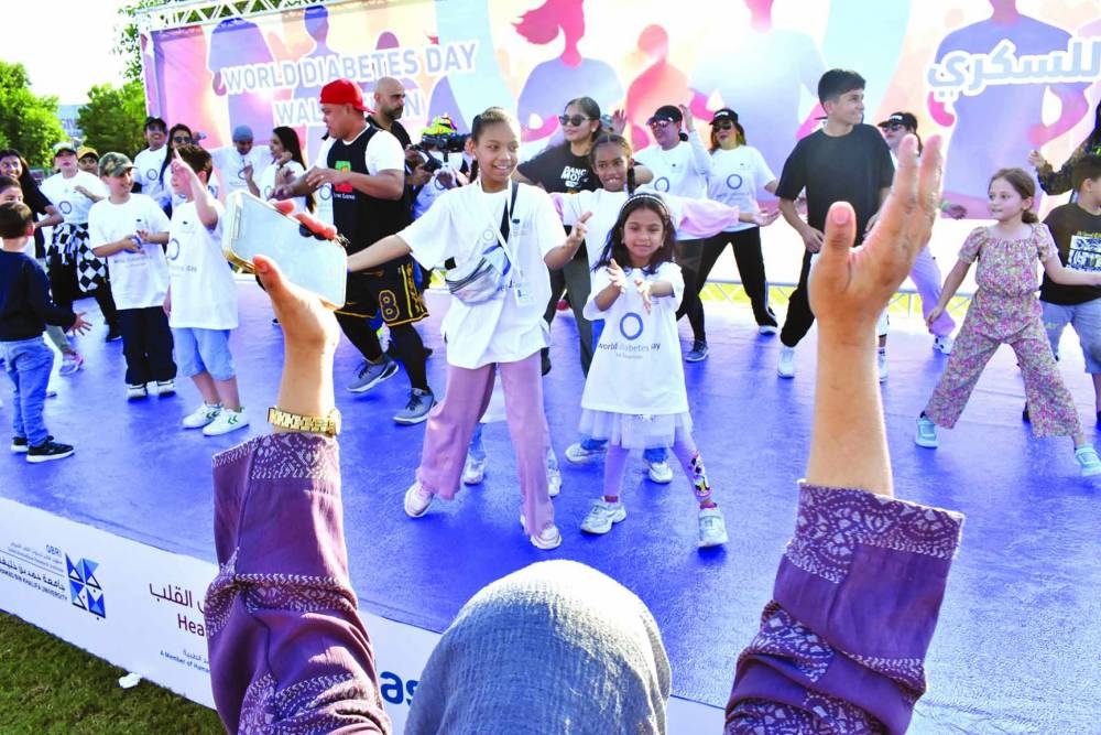 Children join a fitness activity on stage.
