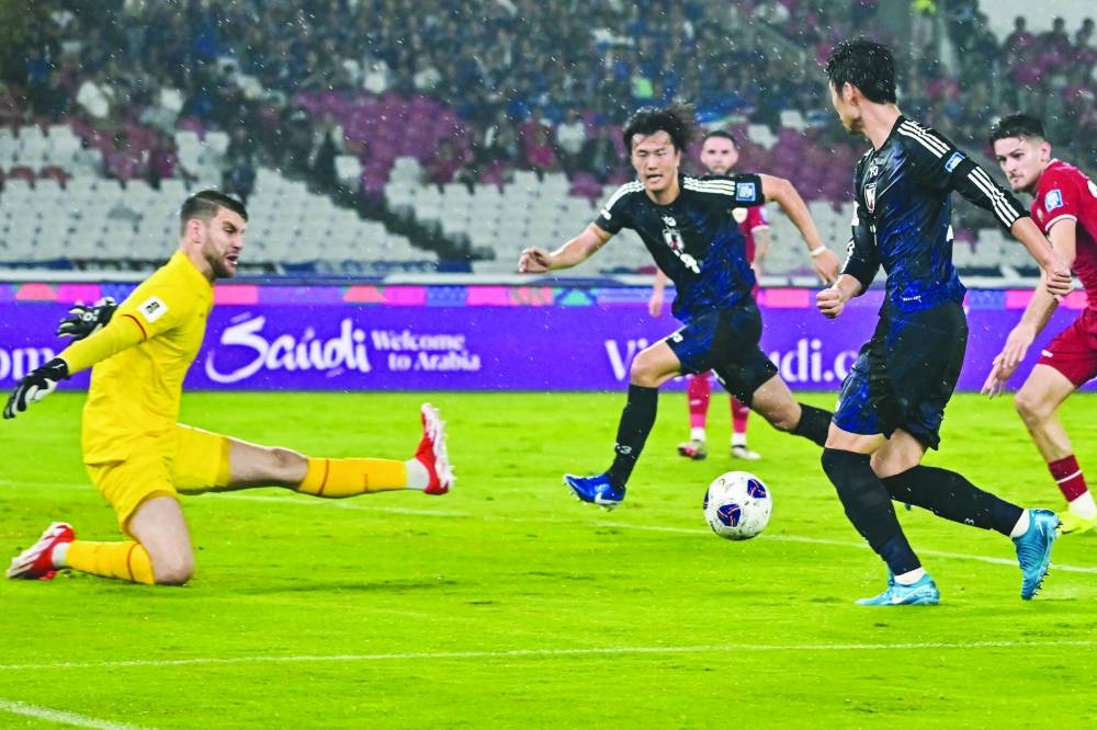 Japan’s Daichi Kamada (right) passes the ball to teammate Koki Ogawa who went on to score during the 2026 World Cup qualification match against Indonesia in Jakarta yesterday. (AFP)