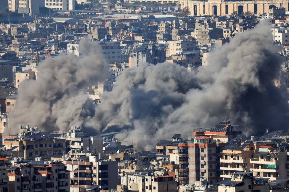 Smoke billows over Beirut's southern suburbs after an Israeli strike as seen from Baabda, Lebanon, on Saturday. REUTERS