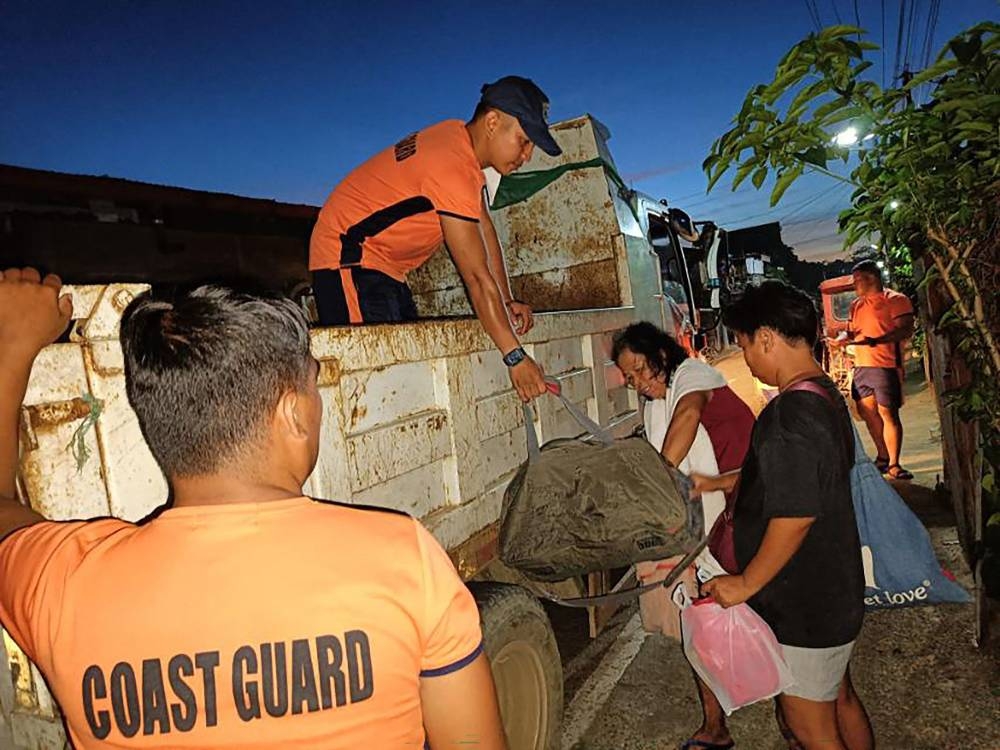 Coast guard personnel evacuating residents during an operation in Virac town, Catanduanes province, ahead of the arrival of Typhoon Many-yi. Photo by Handout / Philippine Coast Guard/ AFP