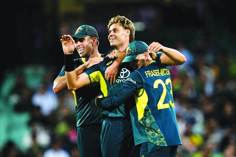 
Australia’s Spencer Johnson (centre) celebrates with teammates after dismissing Pakistan’s Abbas Afridi during the second T20I in Sydney yesterday. (AFP) 