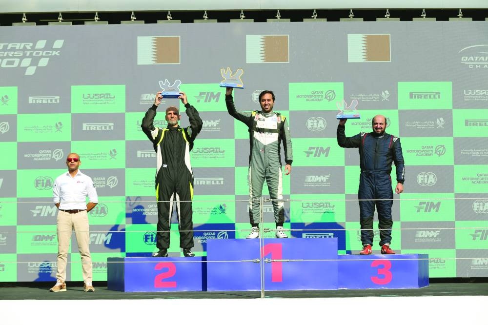 
Amro al-Hamad, Executive Director of QMMF and CEO of Lusail International Circuit, with the podium winners of the Qatar Touring Car Championship. 