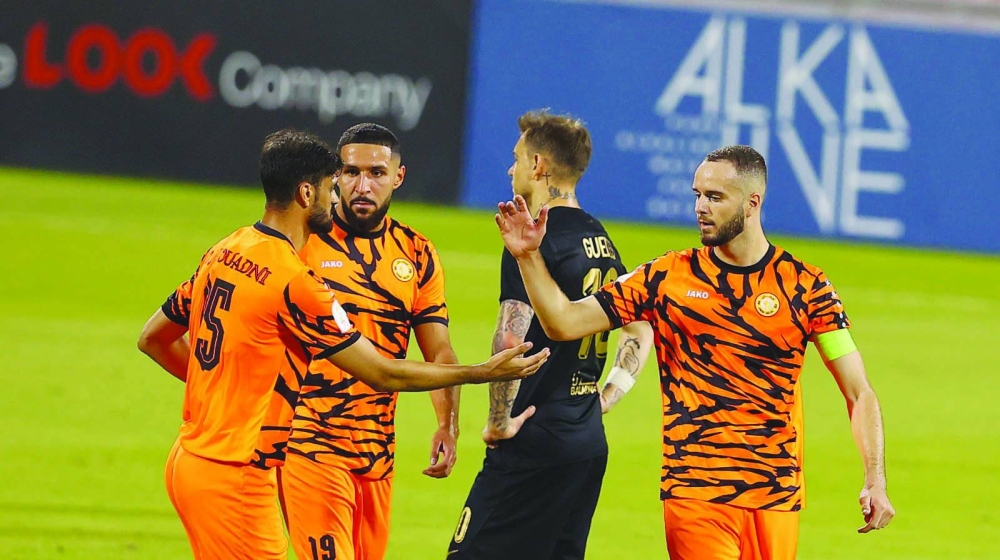 Umm Salal’s Marouane Louadni (left) celebrates with teammates after scoring against Al Rayyan during the QSL Cup quarter-finals at the Grand Hamad Stadium yesterday.