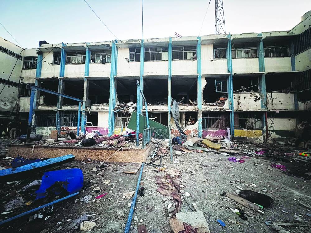A view shows the damage at a school sheltering displaced people, after it was hit by an Israeli strike, in Gaza City Saturday