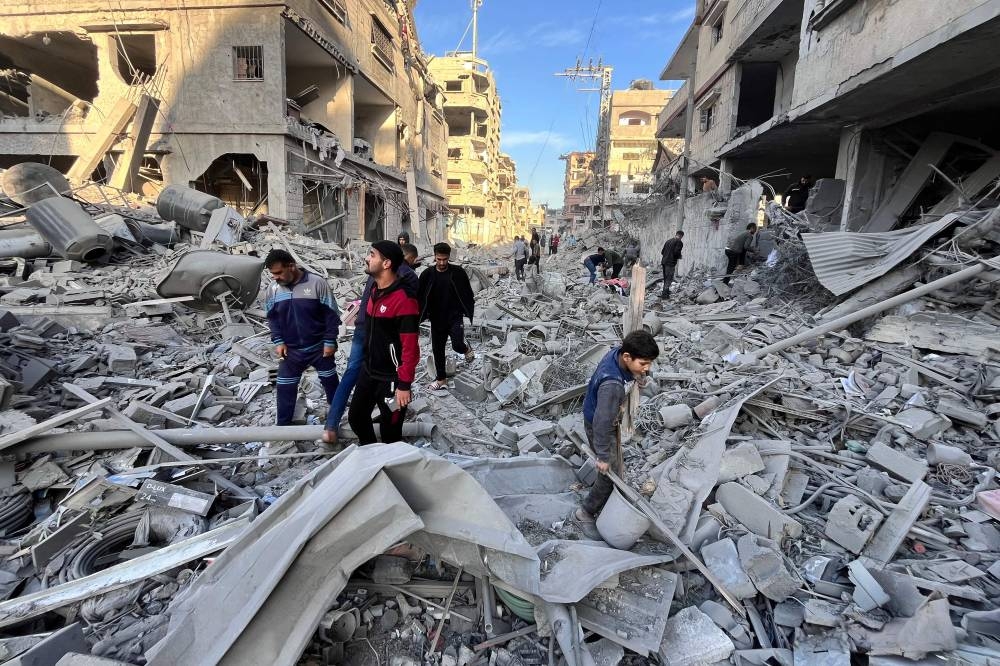 People check the rubble of a building hit in an overnight Israeli strike in Beit Lahya in the northern Gaza Strip, on Sunday. AFP