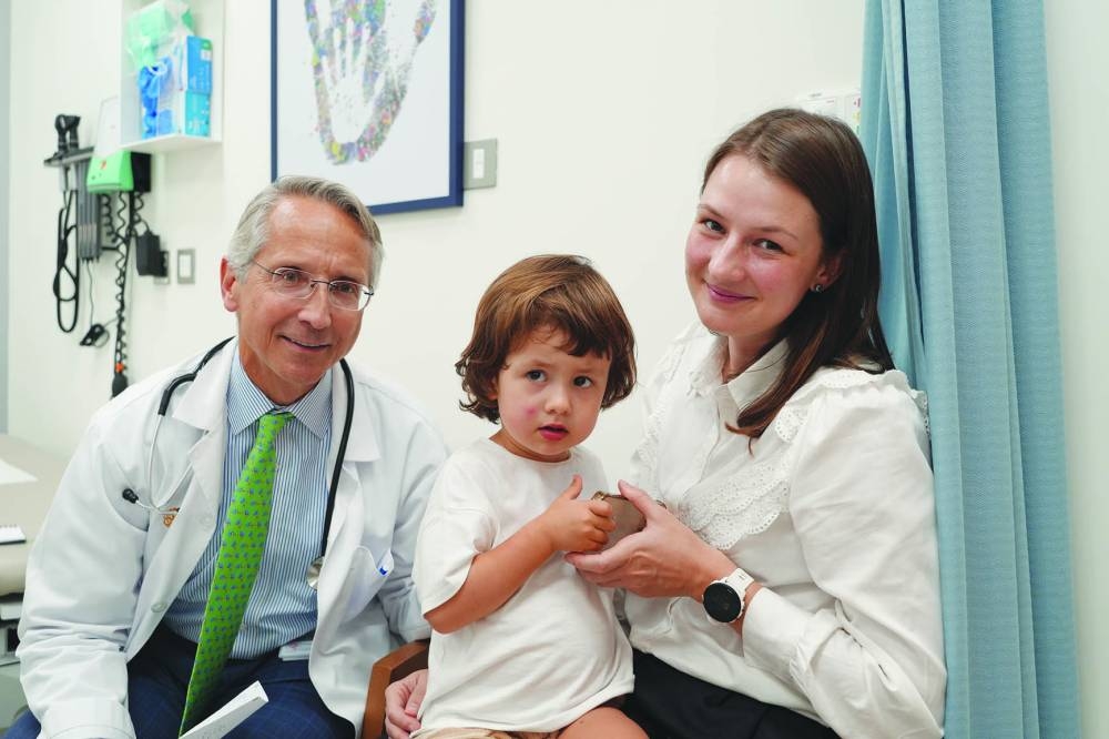 Dr Peter Lechman consulting a child