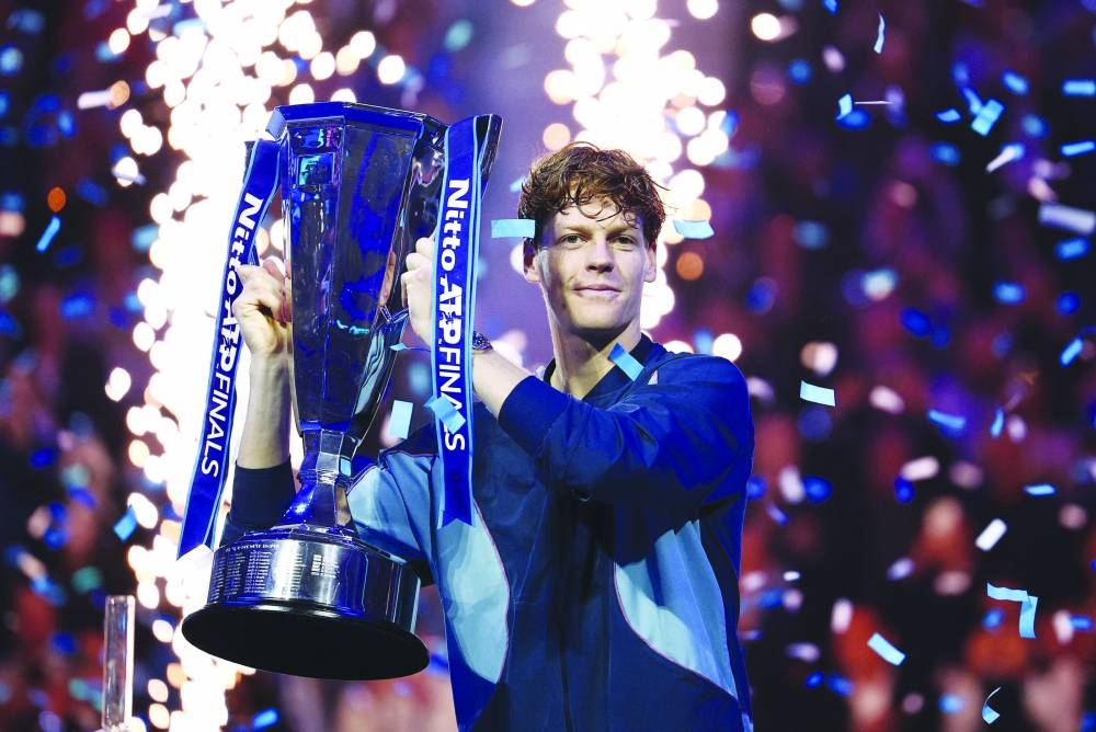 Italy’s Jannik Sinner celebrates with the trophy after winning the ATP Finals against Taylor Fritz of the US at Inalpi Arena, Turin, Italy, yesterday. Sinner won 6-4, 6-4. (Reuters)