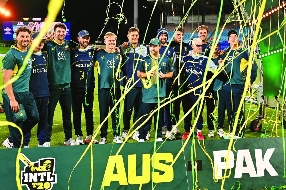 
Australia players celebrate with the trophy after the third Twenty20 against Pakistan at the Bellerive Oval in Hobart yesterday. Australia won the match by seven wickets to take the three-match series 3-0. (AFP) 