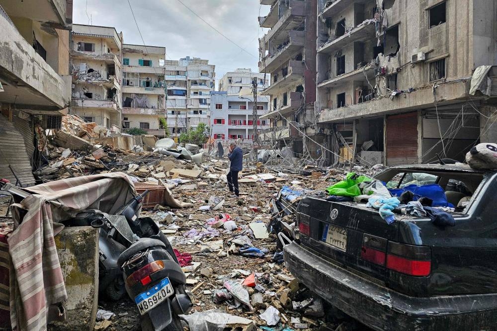 A man walks amid destruction in Beirut’s southern Haret Hreik neighbourhood a day after an Israeli airstrike targeted the site, on Monday. AFP