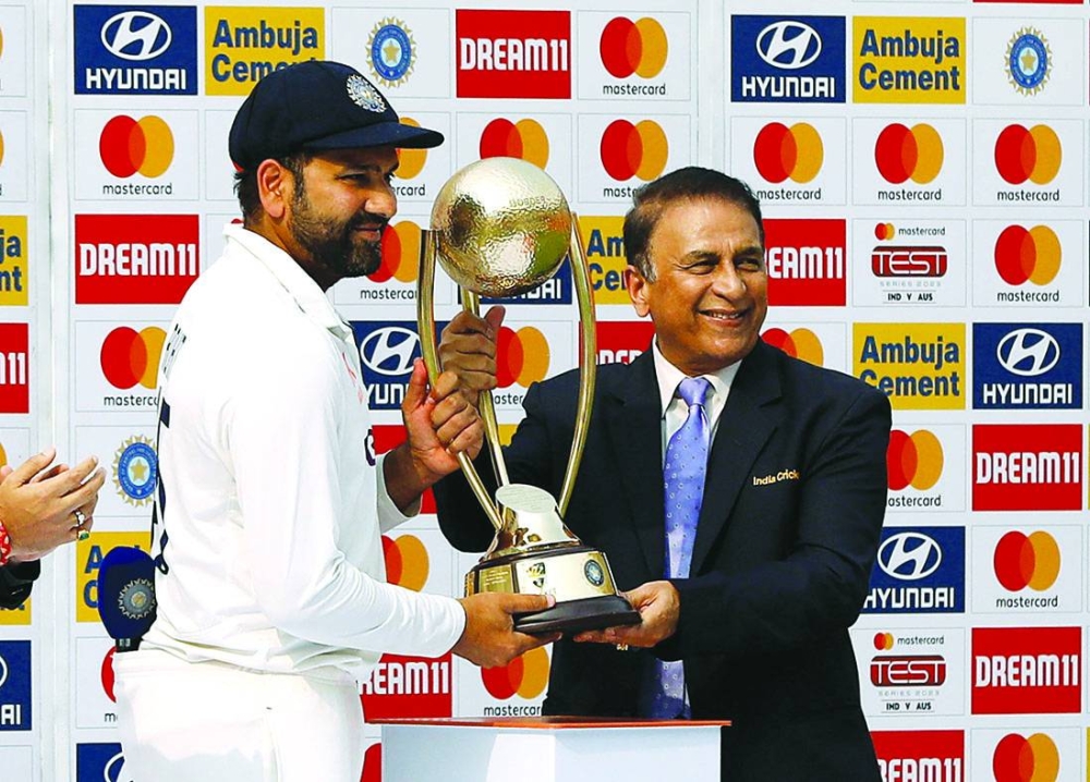 India’s Rohit Sharma receives the Border-Gavaskar Trophy from Sunil Gavaskar after winning the Test series against Australia on March 13, 2023. (Reuters)