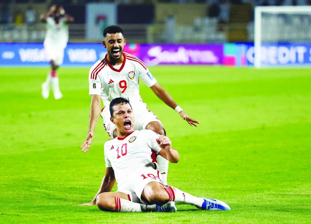 
United Arab Emirates’ Fabio Lima celebrates with Harib Abdalla after scoring his third goal against Qatar at the World Cup qualification match in Abu Dhabi. (Reuters) 