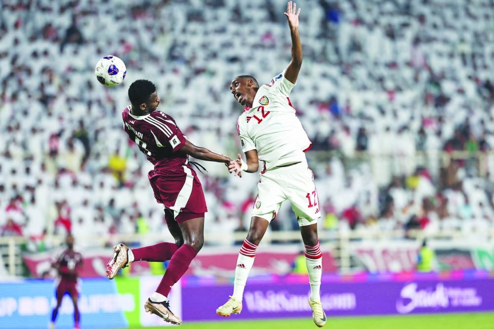 Qatar’s Mohammed Muntari (left) and UAE’s Khalifa al-Hammadi go for a header at the Al Nahyan Stadium in Abu Dhabi.