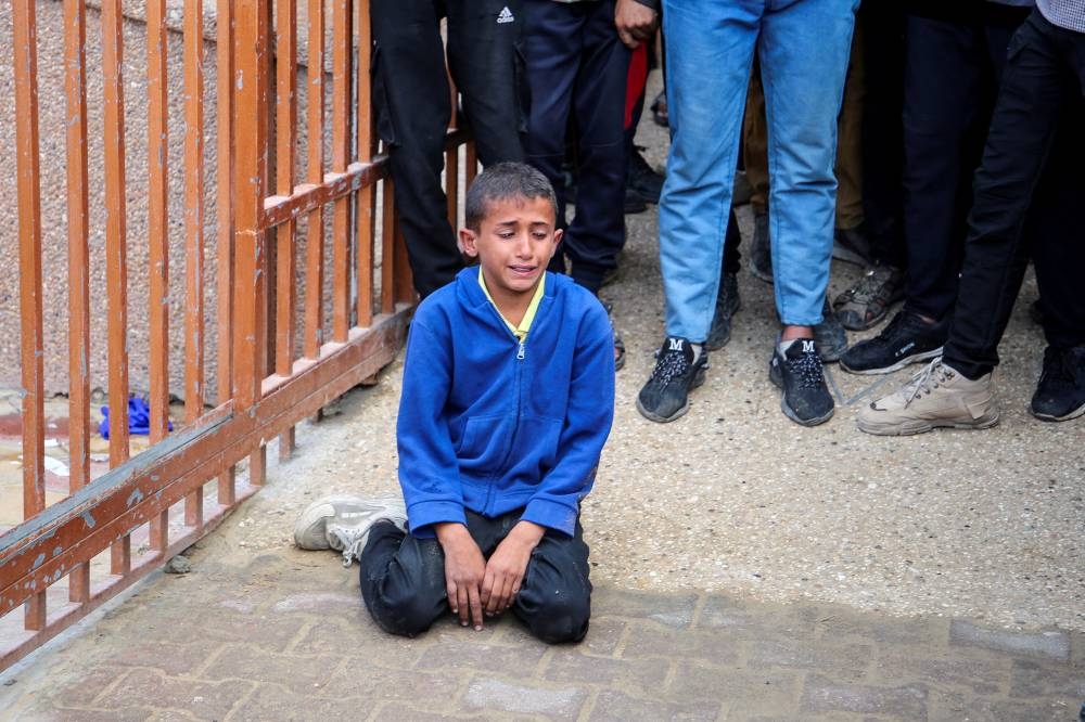 A boy reacts during the funeral of Palestinian Anas Al-Masri, who succumbed to wounds sustained from an Israeli strike, in Khan Younis in the southern Gaza Strip, on Tuesday. REUTERS
